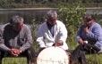 Jean-Baptiste Bellefleur explains to two friends how to make a traditional drum