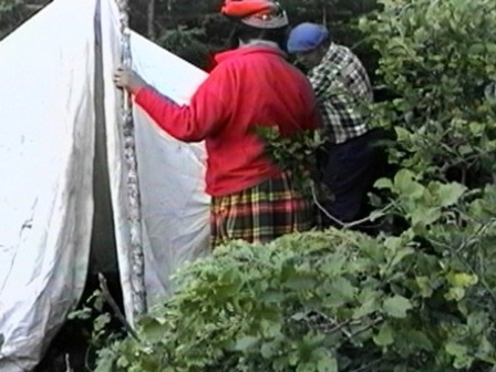 Antoine and Pelashe Bellefleur setting up a tent