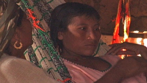 A young Guajira woman receives teachings from a grandmother