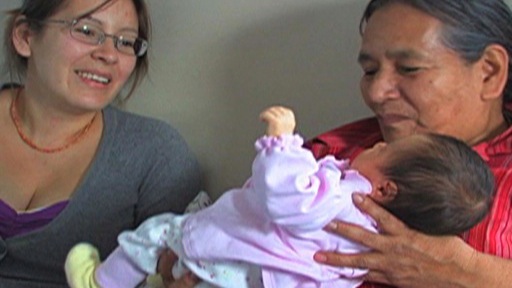 Grandmother, mother and infant in an intimate moment