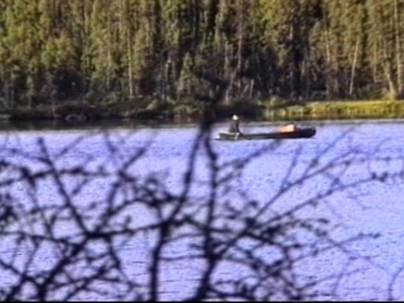 Angling in a canoe by a lake
