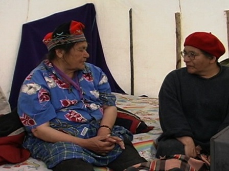Inside a tent, an elder from Natashquan talks with Evelyne St-Onge