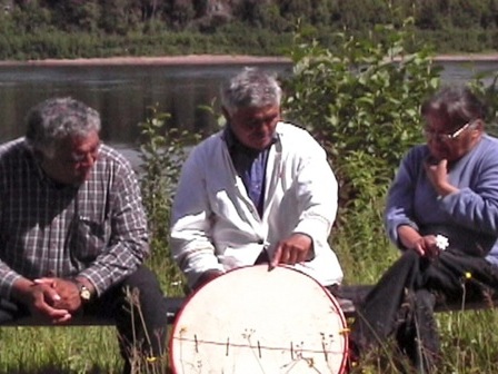 Jean-Baptiste Bellefleur explains to two friends how to make a traditional drum