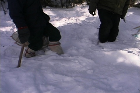 he uses his body weight to trample the snow, to make a place for the tent