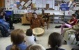 Paul-Émile Dominique explique le tambour traditionnel à des jeunes