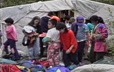 Kids from Montreal’s Arc-en-ciel school in front of a tent in Mani-Utenam