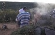 A small group of people exit a sweat lodge