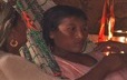 A young Guajira woman receives teachings from a grandmother