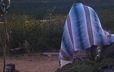 A woman comes out of the sweat lodge