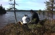 Two hunters prepare to launch their canoe