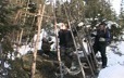 Young Innu putting up a tent in the snow