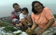 An elder from Ekuanitshit teaches her grandchildren some of her knowledge of plants