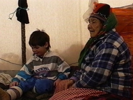 Messenak Bellefleur receives his first snowshoes from his great-grandmother